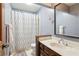 This bathroom features a vanity with a dark wood cabinet, a shower and a toilet at 4812 Lismoor Sw Trce, Mableton, GA 30126