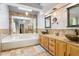 Main bathroom featuring a large soaking tub, double sinks, and granite countertops at 4812 Lismoor Sw Trce, Mableton, GA 30126