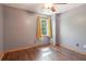 This cozy bedroom features hardwood floors, neutral walls, and a window with bright yellow curtains at 4812 Lismoor Sw Trce, Mableton, GA 30126