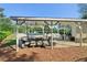 Community pool area with shaded seating, lounge chairs, grilling area and beautifully landscaped surroundings at 4812 Lismoor Sw Trce, Mableton, GA 30126