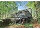 Elevated deck with railings, overlooks the wooded backyard, offering a serene outdoor space for relaxation and entertaining at 4812 Lismoor Sw Trce, Mableton, GA 30126