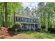 Charming two-story home with a welcoming front porch, surrounded by mature trees and professionally landscaped yard at 4812 Lismoor Sw Trce, Mableton, GA 30126