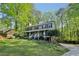 Well-maintained home with a large front lawn, mature trees, and a welcoming porch, perfect for enjoying the outdoors at 4812 Lismoor Sw Trce, Mableton, GA 30126