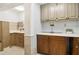 A well-lit laundry room features updated cabinets, providing a functional and stylish workspace at 4812 Lismoor Sw Trce, Mableton, GA 30126