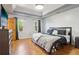 Spacious main bedroom suite with hardwood floors, tray ceiling, and two windows with view at 4812 Lismoor Sw Trce, Mableton, GA 30126