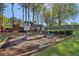 Community playground with a slide, swings, and playhouse with colorful flowers at 4812 Lismoor Sw Trce, Mableton, GA 30126