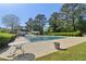 Community pool with covered structure, lounge chairs, and verdant landscaping at 4812 Lismoor Sw Trce, Mableton, GA 30126