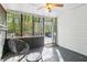 Relax in the screened porch, a tranquil space with open views and modern furniture at 4812 Lismoor Sw Trce, Mableton, GA 30126