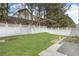 Lawn with a white fence for privacy at 8849 Seneca Rd, Palmetto, GA 30268