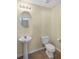 Cozy half bath featuring a pedestal sink and tile flooring at 8849 Seneca Rd, Palmetto, GA 30268