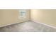 Bedroom with beige walls, window, and gray carpet at 8849 Seneca Rd, Palmetto, GA 30268
