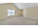 Bright bedroom with vaulted ceilings and neutral carpeting at 8849 Seneca Rd, Palmetto, GA 30268