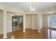 Open-concept dining room showcasing hardwood floors, stylish lighting, and seamless flow to the kitchen at 8849 Seneca Rd, Palmetto, GA 30268