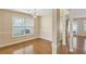 Bright dining room featuring hardwood floors, elegant lighting, and a large window at 8849 Seneca Rd, Palmetto, GA 30268