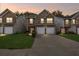 Charming townhome exterior featuring stone accents and a two-car garage, set against a twilight sky at 8849 Seneca Rd, Palmetto, GA 30268
