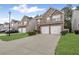 Attractive townhome featuring stone accents, a two-car garage, and a well-manicured lawn at 8849 Seneca Rd, Palmetto, GA 30268