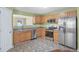 Well-lit kitchen featuring stainless steel appliances and light wood cabinetry at 8849 Seneca Rd, Palmetto, GA 30268