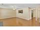Expansive living room showcasing hardwood floors, a ceiling fan, and an open layout to the kitchen at 8849 Seneca Rd, Palmetto, GA 30268