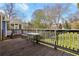 Backyard with a wooden deck and table, with an unfenced lawn at 940 Austin Ave, Atlanta, GA 30307