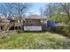 A spacious backyard view with a wooden fence and a home with a deck and stairs at 940 Austin Ave, Atlanta, GA 30307