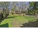 Fenced-in backyard with a lush lawn, mature trees, and plenty of space for outdoor activities at 940 Austin Ave, Atlanta, GA 30307