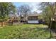 Spacious backyard with neighboring houses in view, framed by trees and a charming picket fence at 940 Austin Ave, Atlanta, GA 30307