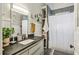 Updated bathroom featuring a shower with black tile and neutral vanity at 940 Austin Ave, Atlanta, GA 30307