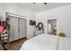 This bright bedroom features hardwood floors, and a closet with clothing at 940 Austin Ave, Atlanta, GA 30307