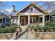 Charming two-story home featuring a welcoming front porch, lovely landscaping, and craftsman style architecture at 940 Austin Ave, Atlanta, GA 30307