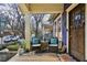 Inviting porch seating area with cushions and decor, perfect for enjoying neighborhood views and relaxing outdoors at 940 Austin Ave, Atlanta, GA 30307