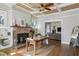Spacious living room featuring hardwood floors, a brick fireplace, and an open concept to the dining area at 940 Austin Ave, Atlanta, GA 30307