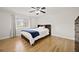This bedroom features hardwood floors, a ceiling fan, a queen bed, and a large window for ample natural light at 1468 Briarwood Ne Rd # 810, Brookhaven, GA 30319
