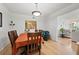 The dining room features hardwood floors, an orange table cloth, seating for four, and an opening to the living room at 1468 Briarwood Ne Rd # 810, Brookhaven, GA 30319