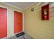 Close-up of condo entrance with a red door, and a fire extinguisher at 1468 Briarwood Ne Rd # 810, Brookhaven, GA 30319
