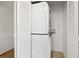 This laundry room features a stackable washer and dryer, and white wood doors at 1468 Briarwood Ne Rd # 810, Brookhaven, GA 30319