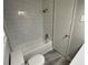 Bright bathroom with a new tiled shower-tub combination and updated fixtures at 3467 Valley Ridge Sw Ter, Atlanta, GA 30331