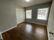Light-filled bedroom featuring two windows, hardwood floors, and ample closet space at 3467 Valley Ridge Sw Ter, Atlanta, GA 30331