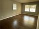 Inviting bedroom featuring gleaming hardwood floors, neutral walls, and natural light from two windows at 3467 Valley Ridge Sw Ter, Atlanta, GA 30331
