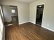 Open dining room with hardwood floors that leads to a modern kitchen with white cabinets at 3467 Valley Ridge Sw Ter, Atlanta, GA 30331