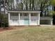 Charming two-story brick home with a light blue front door and a covered carport on a wooded lot at 3467 Valley Ridge Sw Ter, Atlanta, GA 30331