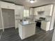 Modern kitchen featuring white cabinets, stainless steel appliances, granite countertops, and a central island at 3467 Valley Ridge Sw Ter, Atlanta, GA 30331