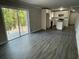 A living room with vinyl floors that leads to a modern kitchen and a sliding door to a patio at 3467 Valley Ridge Sw Ter, Atlanta, GA 30331
