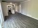 Open-concept living room flows into a modern kitchen with stainless steel appliances and new grey flooring at 3467 Valley Ridge Sw Ter, Atlanta, GA 30331