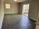 A living room with vinyl floors and a sliding door leading to a patio at 3467 Valley Ridge Sw Ter, Atlanta, GA 30331