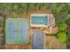 Aerial view showcasing community amenities including a pool, tennis courts, clubhouse, and ample parking at 3904 Tristan Way, Suwanee, GA 30024