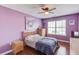 Cozy bedroom with purple walls, hardwood floors, and natural light at 3904 Tristan Way, Suwanee, GA 30024