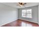 Neutral bedroom with hardwood floors, ceiling fan, and a large window at 3904 Tristan Way, Suwanee, GA 30024