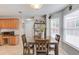 Bright breakfast area with a large window, hardwood table and chairs, and a view of the surrounding kitchen at 3904 Tristan Way, Suwanee, GA 30024