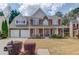 Charming two-story home with a well-manicured front yard, stone accents, red shutters and a welcoming front porch at 3904 Tristan Way, Suwanee, GA 30024