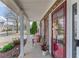 Inviting front porch featuring stone accents and a red front door, with seating at 3904 Tristan Way, Suwanee, GA 30024